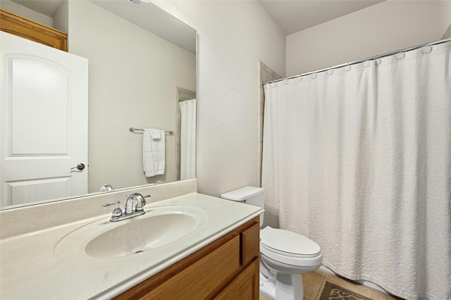 bathroom with vanity, toilet, and tile patterned floors