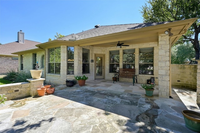 back of property featuring ceiling fan and a patio area