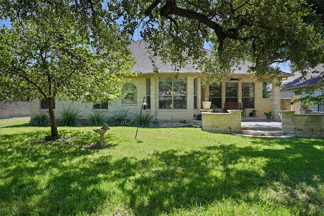 back of house with a lawn