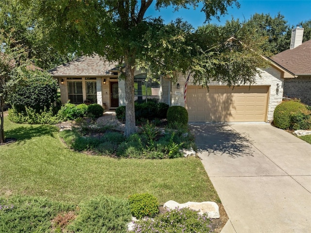 view of front of home featuring a garage and a front lawn