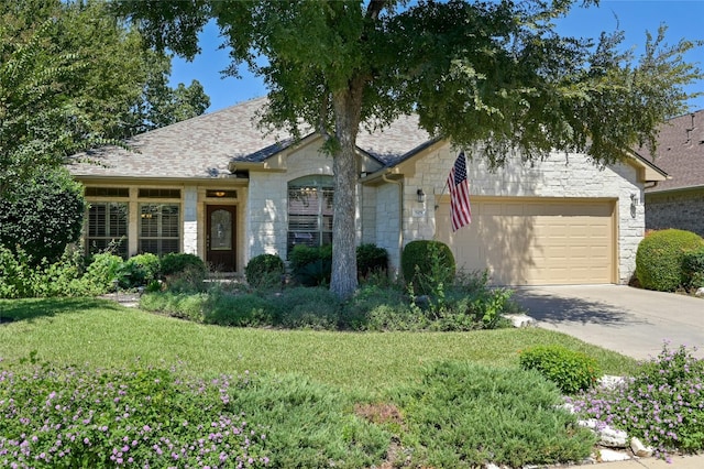 view of front of home featuring a garage and a front yard