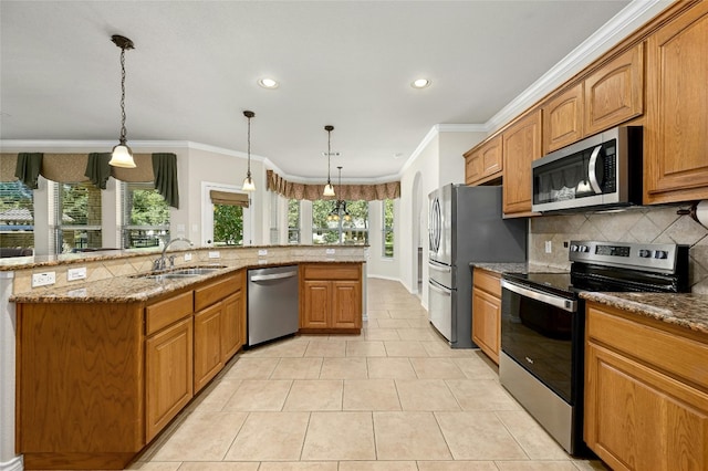 kitchen with decorative light fixtures, stainless steel appliances, sink, light stone countertops, and light tile patterned flooring