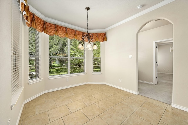 empty room featuring ornamental molding, a chandelier, and light tile patterned flooring