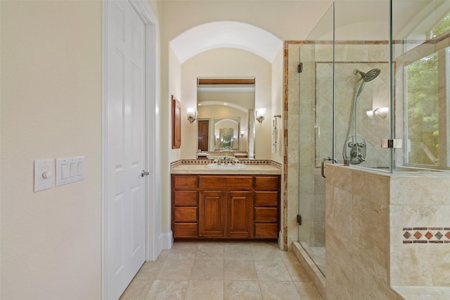 bathroom with walk in shower, tile patterned floors, and vanity