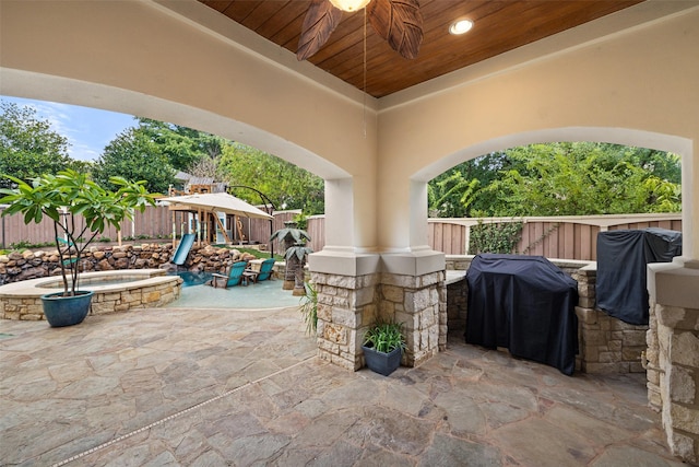 view of patio with a playground, area for grilling, and ceiling fan