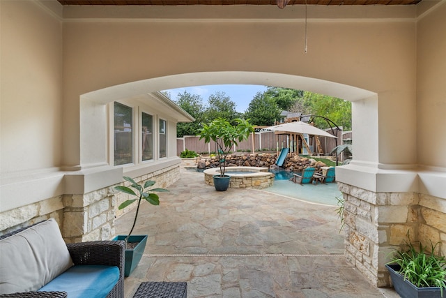 view of patio with an in ground hot tub