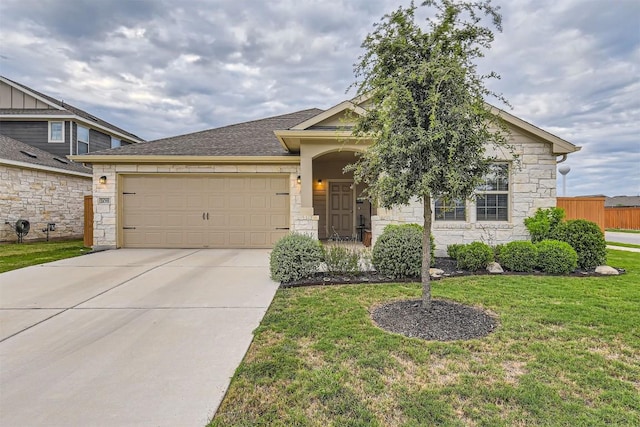 view of front of property with a front lawn and a garage