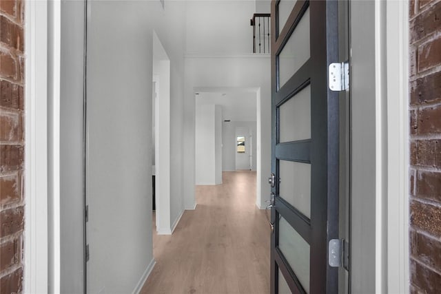 hallway with light hardwood / wood-style floors