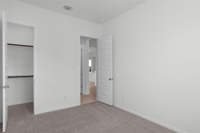 unfurnished bedroom with carpet floors and a closet