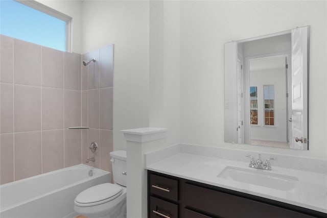 full bathroom with vanity, toilet, and tiled shower / bath combo