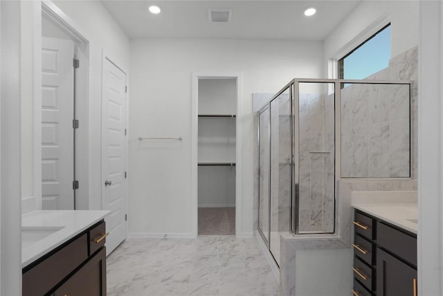 bathroom featuring vanity and a shower with shower door