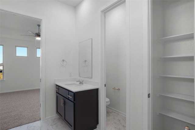 bathroom featuring vanity, ceiling fan, and toilet