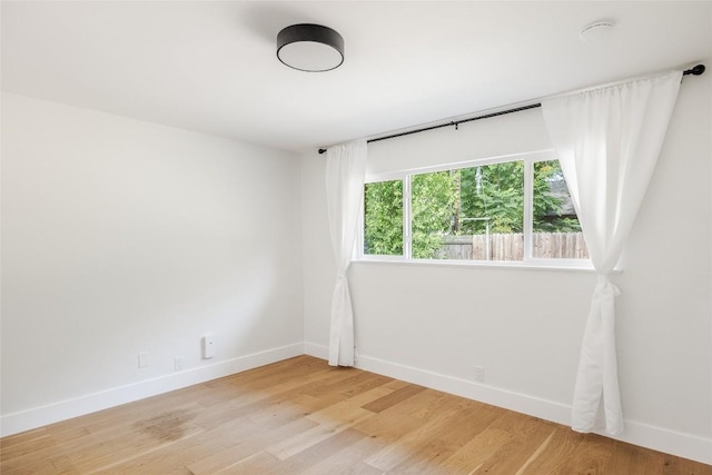 spare room with light hardwood / wood-style flooring