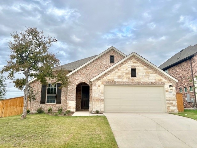 view of front of home with a garage and a front yard