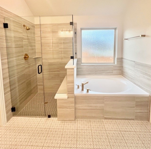 bathroom featuring tile patterned flooring and independent shower and bath