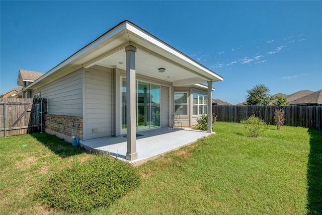 back of house with a yard and a patio area