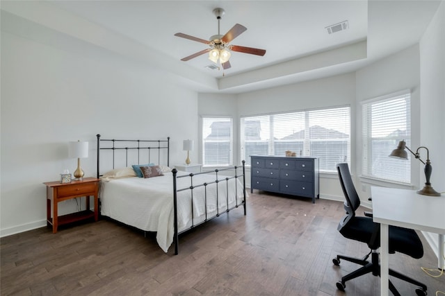 bedroom featuring a tray ceiling, hardwood / wood-style floors, and ceiling fan