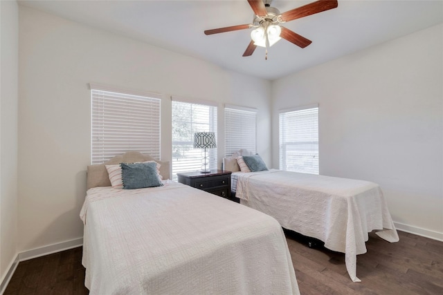 bedroom with ceiling fan and dark hardwood / wood-style flooring