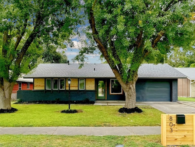 single story home with a garage and a front yard