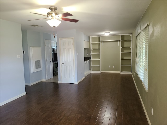 interior space with multiple closets, dark wood-type flooring, and ceiling fan