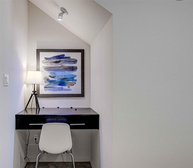 office space with lofted ceiling and baseboards