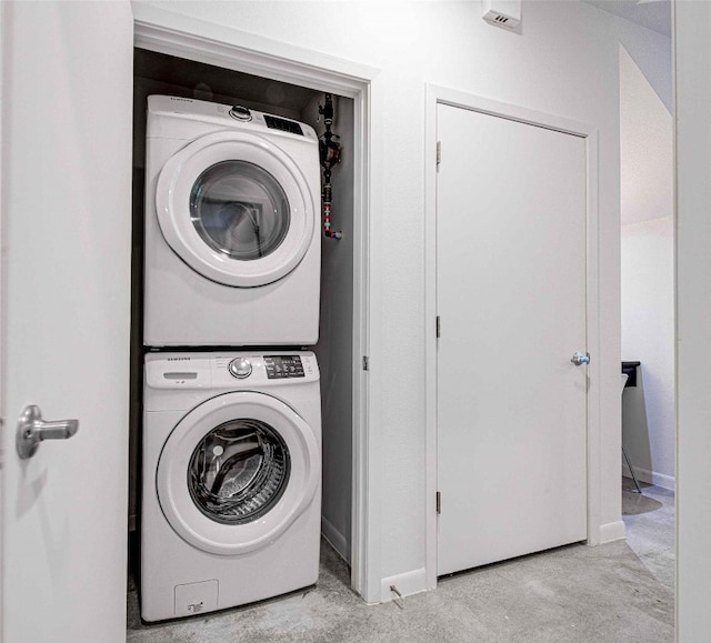 laundry area with stacked washing maching and dryer