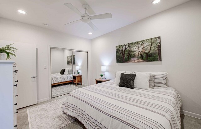 carpeted bedroom with ceiling fan and a closet