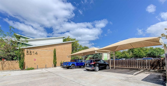 partially covered parking lot with fence