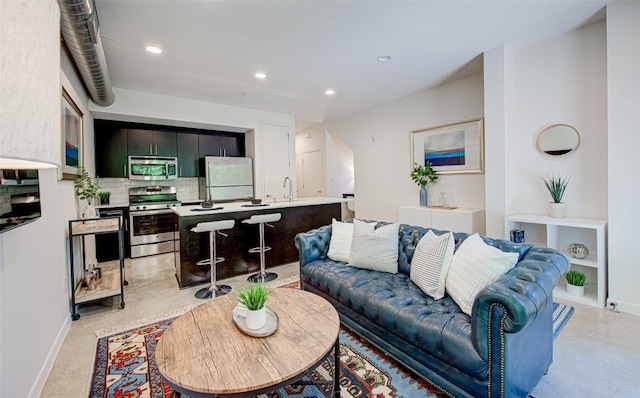 living area with baseboards and recessed lighting