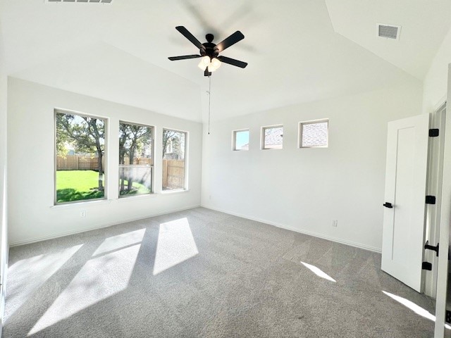 carpeted empty room featuring ceiling fan and lofted ceiling