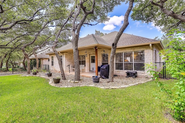 rear view of property with a patio area and a yard