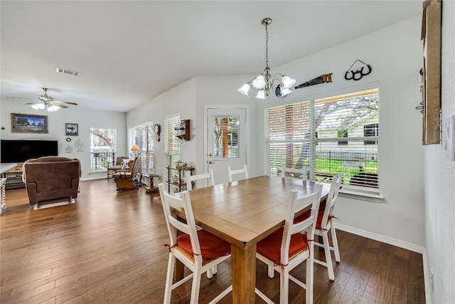 dining space featuring dark wood-type flooring and ceiling fan with notable chandelier