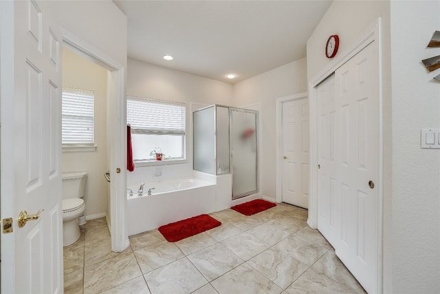 bathroom featuring toilet and separate shower and tub