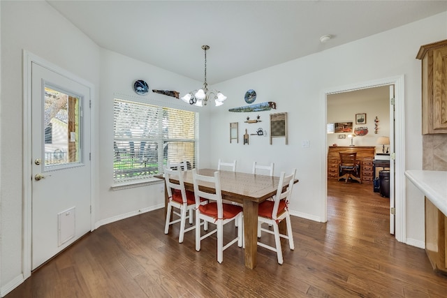 dining area with a notable chandelier and dark hardwood / wood-style flooring