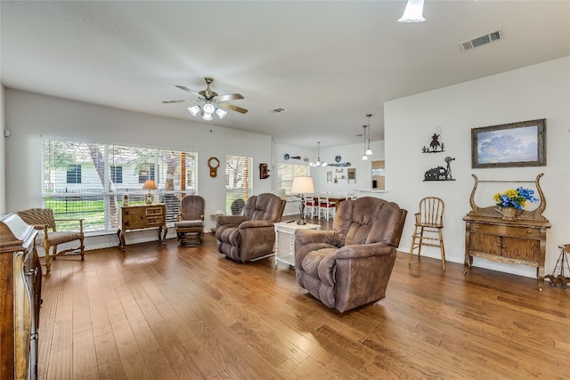 living room featuring ceiling fan and hardwood / wood-style flooring