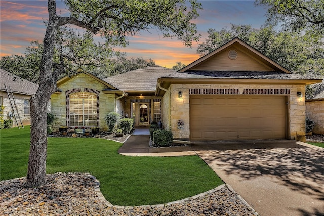 view of front facade with a garage and a yard