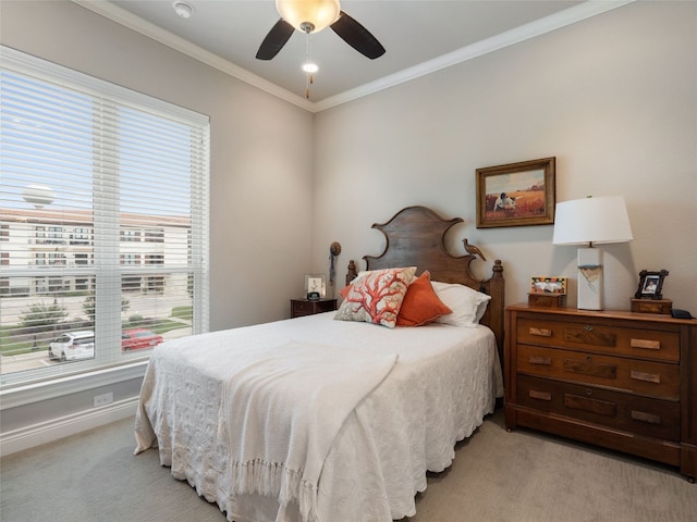 carpeted bedroom featuring crown molding and ceiling fan