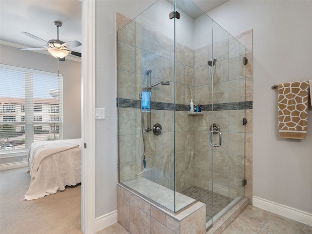 bathroom featuring a shower with door, ceiling fan, and tile patterned floors