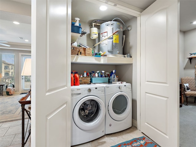 laundry room with ornamental molding, ceiling fan, separate washer and dryer, and electric water heater