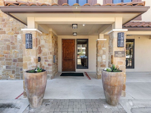 view of exterior entry featuring a porch