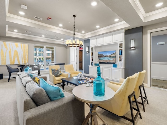 carpeted living room with a tray ceiling, crown molding, and a notable chandelier