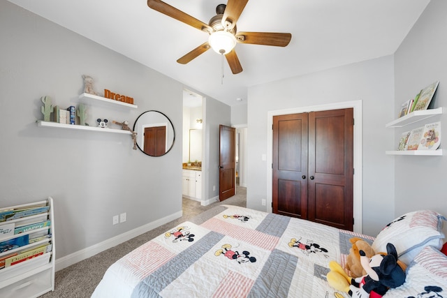 carpeted bedroom with ceiling fan, a closet, and ensuite bath