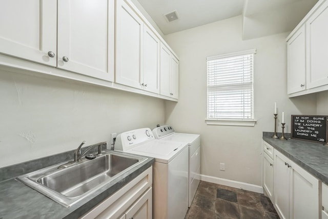 laundry room with cabinets, sink, and washing machine and dryer