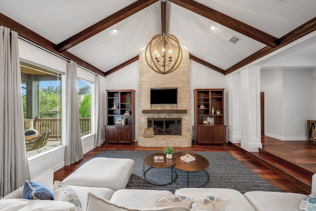 living room featuring a stone fireplace, ornate columns, an inviting chandelier, dark hardwood / wood-style floors, and lofted ceiling with beams