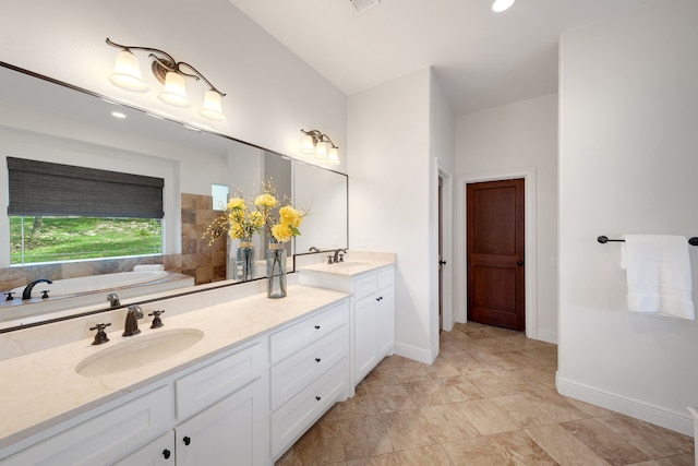 bathroom with vanity and a bath