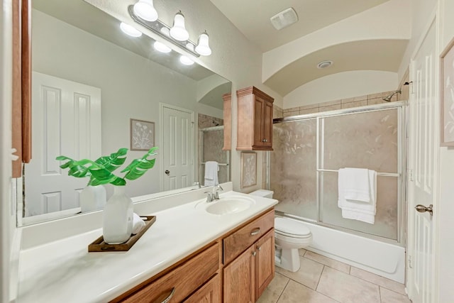 full bathroom featuring tile patterned flooring, toilet, combined bath / shower with glass door, and vanity