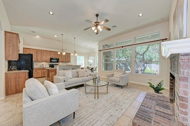 living room with ceiling fan, light tile patterned floors, and a brick fireplace