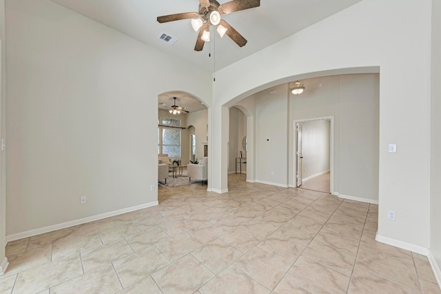 spare room featuring ceiling fan and vaulted ceiling