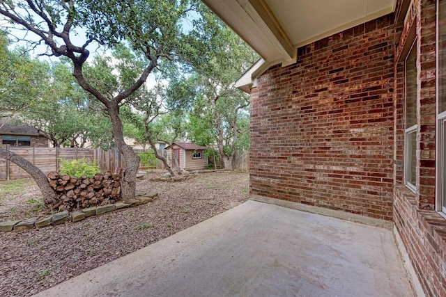 view of patio with a storage unit