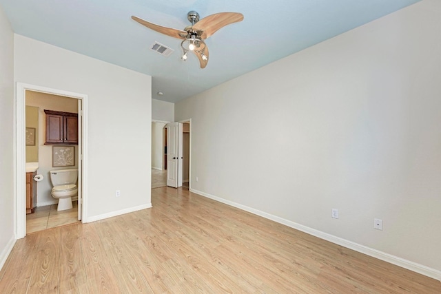 unfurnished bedroom with light hardwood / wood-style flooring, ceiling fan, and ensuite bathroom